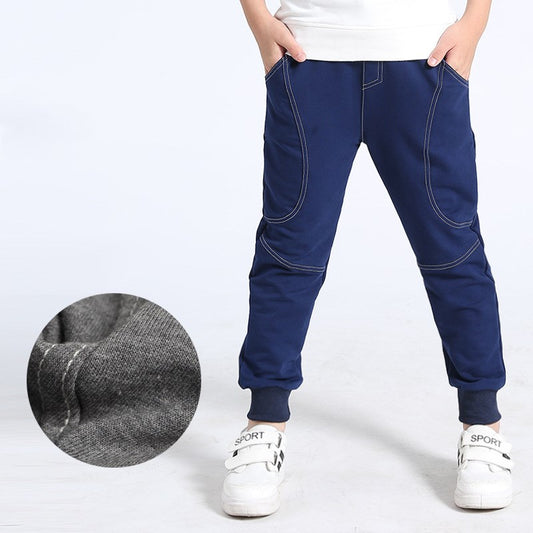 Boy wearing Ancient Energy boys' sports trousers, athletic pants with sporty design and comfortable fit for active wear.