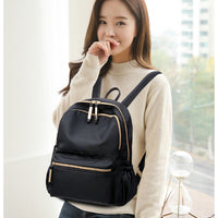 Waterproof black Oxford backpack for women by Ancient Energy, featuring multiple compartments and comfortable straps for school use.