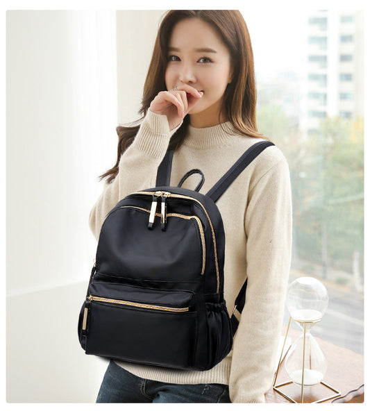 Waterproof black Oxford backpack for women by Ancient Energy, featuring multiple compartments and comfortable straps for school use.