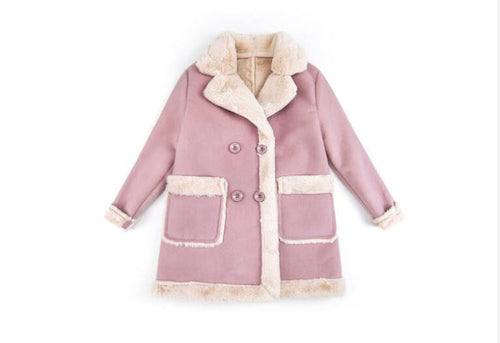 Young child wearing warm winter clothing from Ancient Energy, layered jacket and winter accessories for kids.