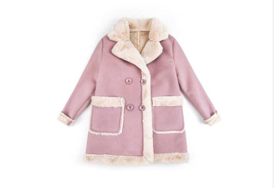 Young child wearing warm winter clothing from Ancient Energy, layered jacket and winter accessories for kids.