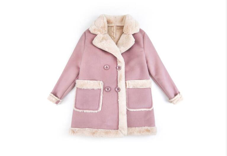 Young child wearing warm winter clothing from Ancient Energy, layered jacket and winter accessories for kids.