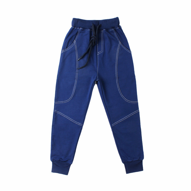 Young boy wearing Ancient Energy boys' sports trousers, athletic pants with a comfortable fit and sporty design.