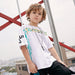 Children's printed T-shirt by Ancient Energy featuring colorful fun design, soft fabric, and comfortable fit for kids.