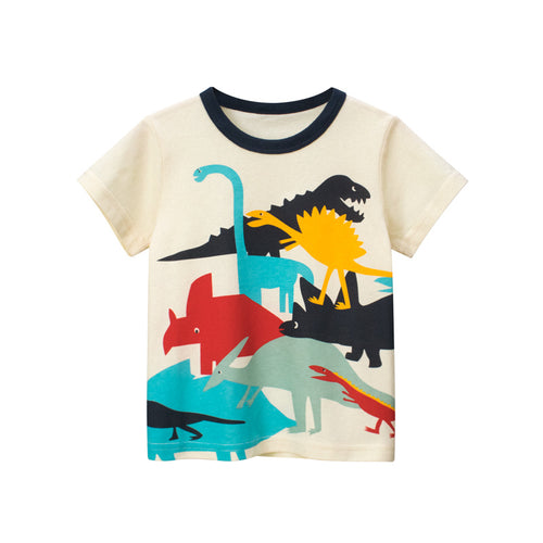 Boy wearing a Boys Short Sleeve T-Shirt by Ancient Energy with a colorful dinosaur cartoon design on the front.