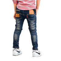 Young boy wearing blue stretch denim pants from Ancient Energy, casual style with comfortable fit and classic five-pocket design.