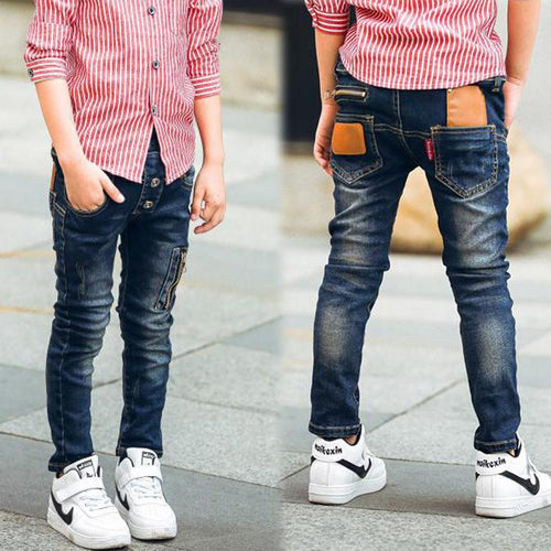 Boy wearing Ancient Energy stretch denim pants, casual boys' jeans with a classic fit and blue denim fabric.