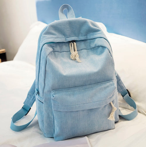 Ancient Energy corduroy backpack with shoulder straps, designed for students, featuring a spacious school bag style in a stylish fabric.