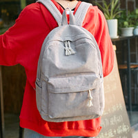 Ancient Energy corduroy backpack for students with shoulder straps, ideal for school and daily use, in a stylish design.