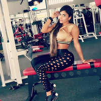 Black ankle-length women's leggings by Ancient Energy with round holes, quick-dry cotton fabric, push-up design, ideal for workouts.