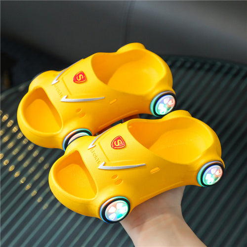 Kids glowing cartoon car slippers from Ancient Energy, luminous slip-on sandals with anti-slip soles, perfect for summer beach wear.