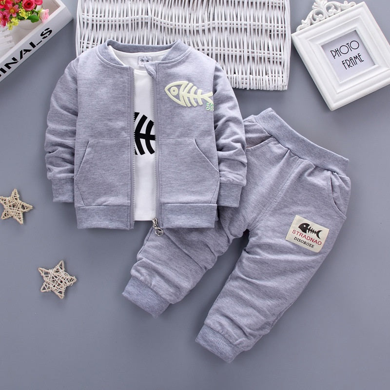 Children's three-piece clothing set by Ancient Energy, featuring colorful shirts and pants for kids.