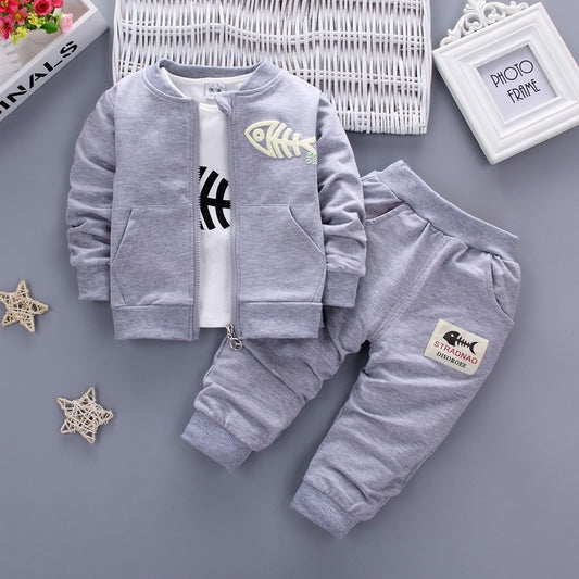 Children's three-piece clothing set by Ancient Energy, featuring colorful shirts and pants for kids.