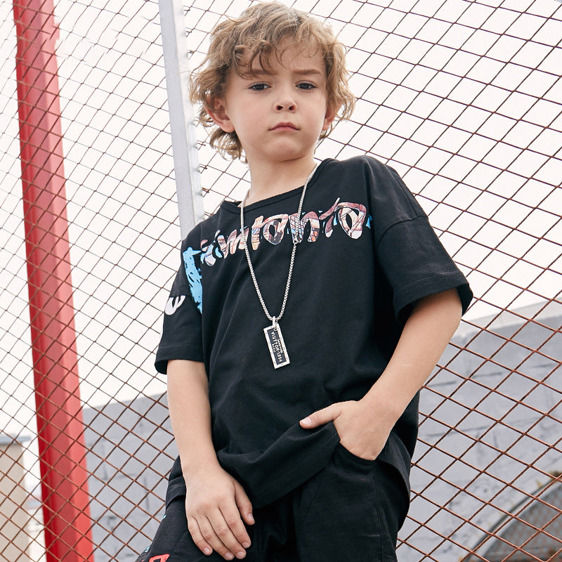 Children's printed T-shirt by Ancient Energy featuring colorful cartoon designs on soft fabric.