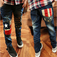 Children's boys' denim trousers by Ancient Energy, showing classic blue jeans with front and back pockets and belt loops.