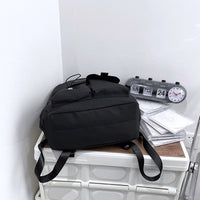 Ancient Energy nylon school backpack for junior high students with multiple compartments and adjustable straps.
