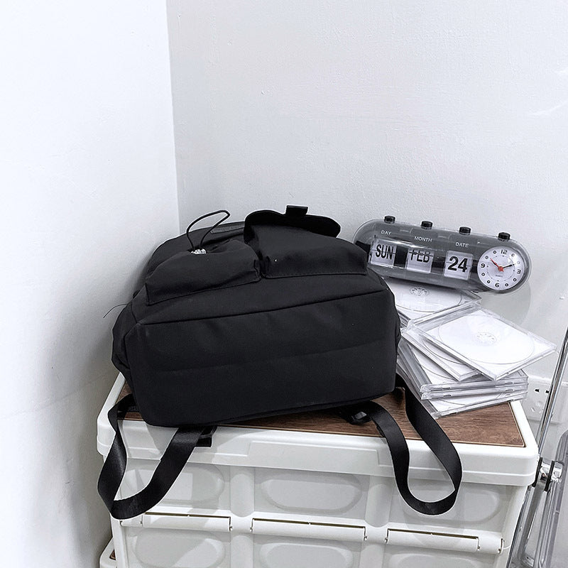 Ancient Energy nylon school backpack for junior high students with multiple compartments and adjustable straps.