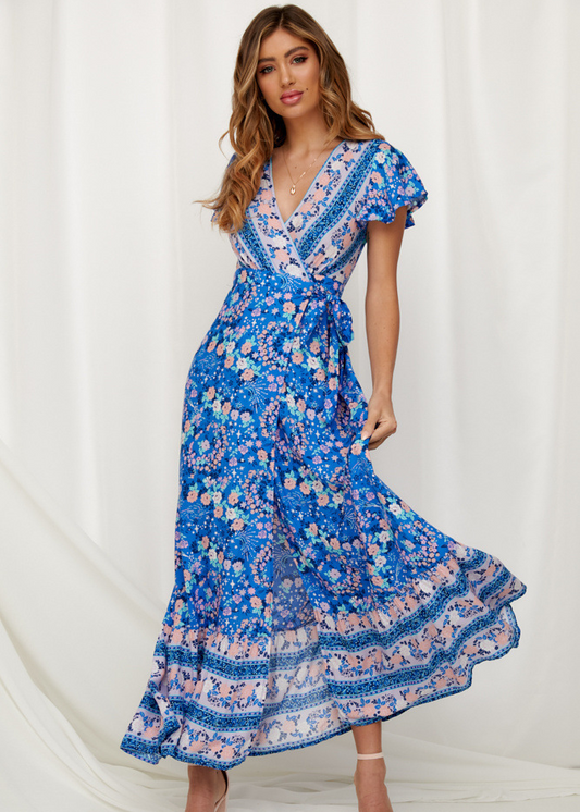 Mandotos International Tropical Bloom Maxi Dress with vibrant floral pattern and flowing fabric for elegant summer wear.