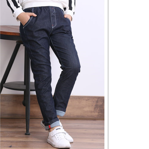 Children's boys' jeans with thick fleece lining, winter casual wear by Ancient Energy, showing denim pants for kids in a cozy setting.