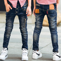 Boy wearing Ancient Energy stretch denim pants, casual boys' denim trousers with a comfortable fit and classic blue wash.