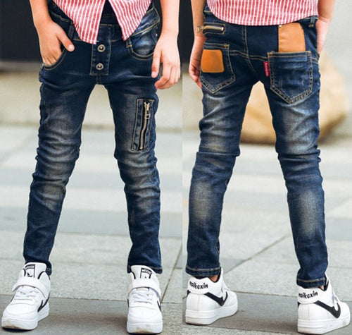 Boy wearing Ancient Energy stretch denim pants, casual boys' denim trousers with a comfortable fit and classic blue wash.