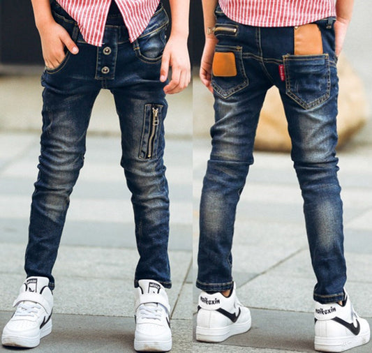 Boy wearing Ancient Energy stretch denim pants, casual boys' denim trousers with a comfortable fit and classic blue wash.