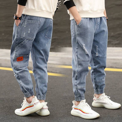 Young boy wearing loose Western-style boys' jeans and trousers from Ancient Energy, suitable for primary school students.