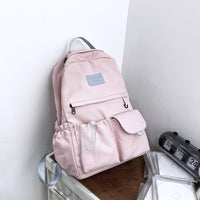 Ancient Energy nylon school backpack for junior high students with multiple compartments and adjustable straps.