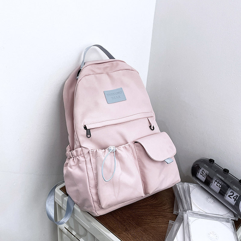 Ancient Energy nylon school backpack for junior high students with multiple compartments and adjustable straps.