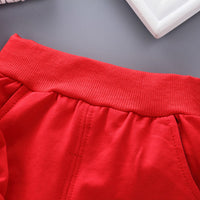 Children's three-piece clothing set from Ancient Energy, featuring colorful tops and pants for kids.