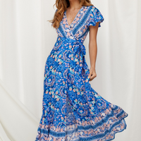 Mandotos International Tropical Bloom Maxi Dress with vibrant floral pattern and flowing fabric, perfect for summer occasions.