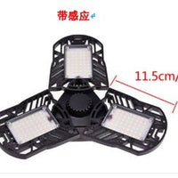 Ancient Energy 60W super bright deformable LED light illuminating gym, warehouse, or garage with 6000 lumens brightness.