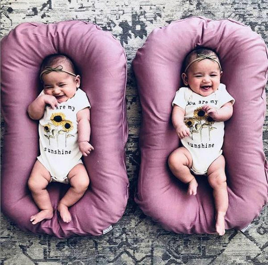 Ancient Energy baby nest bed crib with soft cotton cushion, portable infant cradle for newborns and travel convenience.