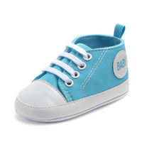 Ancient Energy canvas sports sneakers for babies and toddlers, soft sole, anti-slip infant first walkers shoes in blue and white.