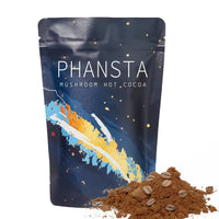 Ancient Energy Cocoa Ground Coffee in a jar, showing rich brown powder with a scoop for brewing and tasting.