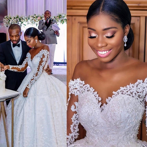 Elegant custom wedding gown by Ancient Energy featuring intricate lace details and a flowing train for bridal elegance.