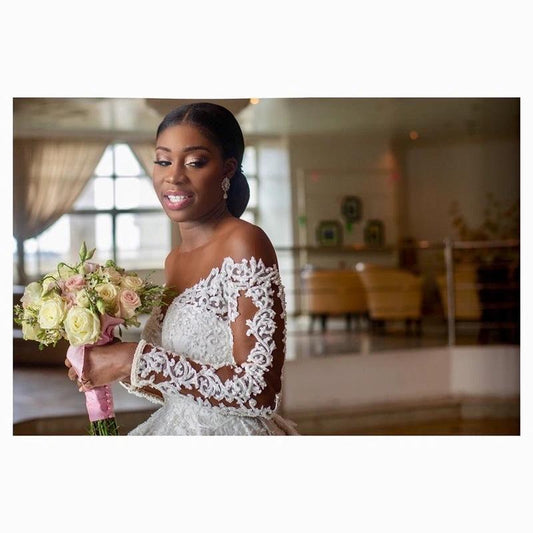 Elegant custom wedding gown by Ancient Energy featuring intricate lace details and a flowing train for bridal elegance.