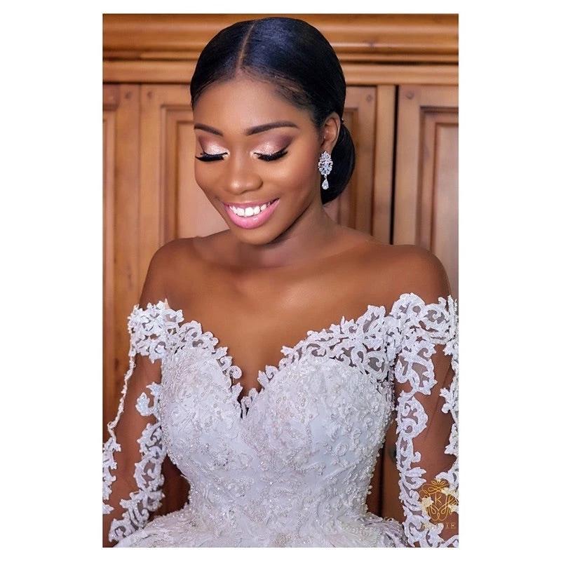 Elegant custom wedding gown by Ancient Energy, featuring intricate lace details and a flowing train, perfect for bridal occasions.