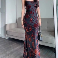 Ancient Energy black flocked strappy maxi dress with a flowing silhouette and intricate textured fabric.