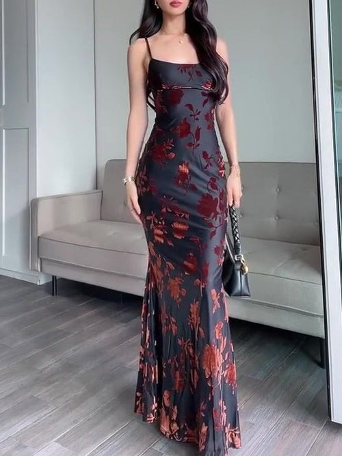 Ancient Energy black flocked strappy maxi dress with a flowing silhouette and intricate textured fabric.