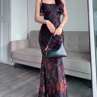 Ancient Energy flocked strappy maxi dress in black, featuring a fitted bodice and flowing skirt, stylish evening wear.