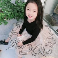 Girls' dress by Ancient Energy in soft pastel with floral pattern, sleeveless design, and ruffled hem for a charming look.