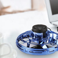 Ancient Energy LED UFO flying helicopter spinner toy for kids, featuring colorful lights and spinning motion.