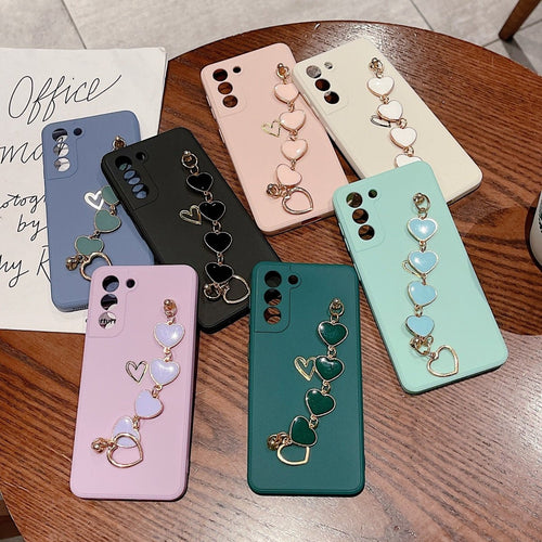 Ancient Energy Love Chain phone case with bronzing hollow design, drop-resistant construction for iPhone or smartphone protection.