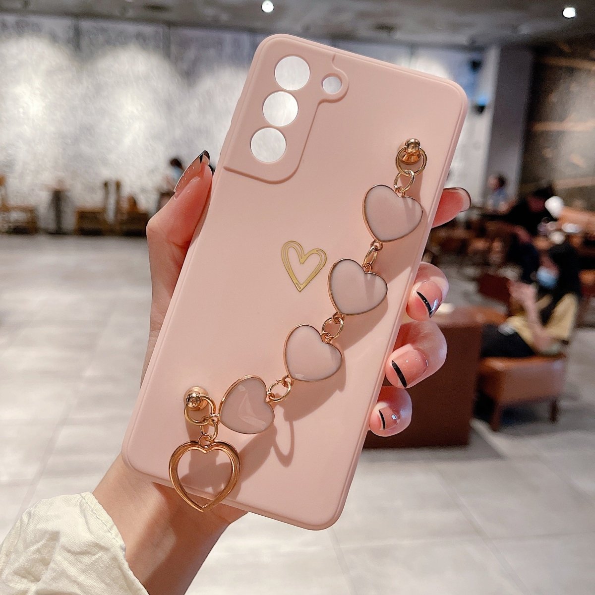 Ancient Energy Love Chain phone case with bronze hollow design, drop-resistant protection, and stylish appearance.