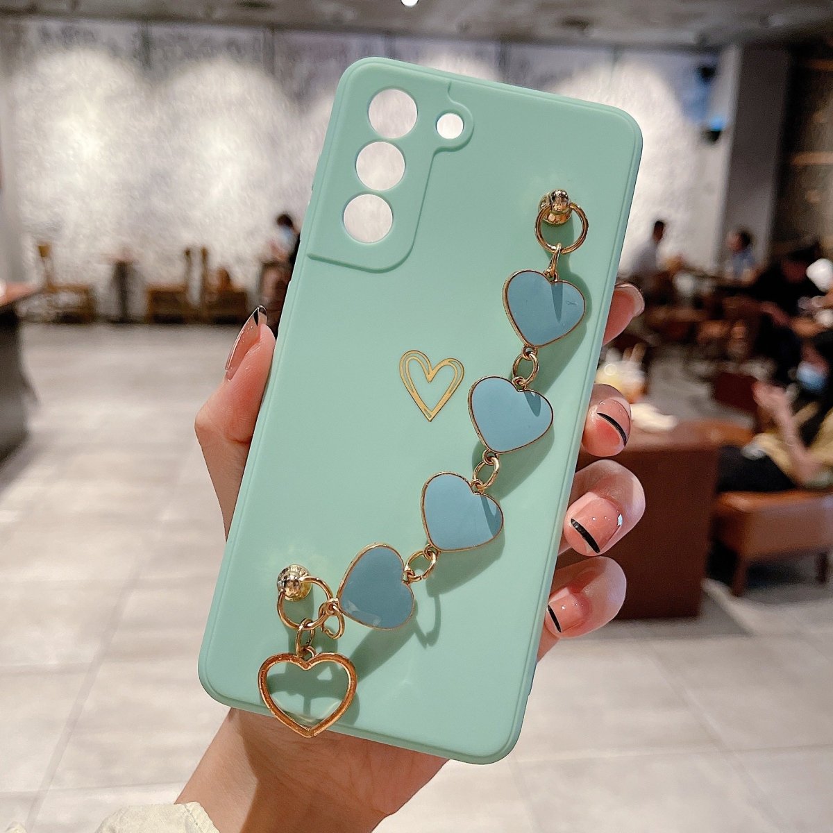 Ancient Energy Love Chain phone case featuring bronzing hollow design and drop-resistant construction for iPhone.