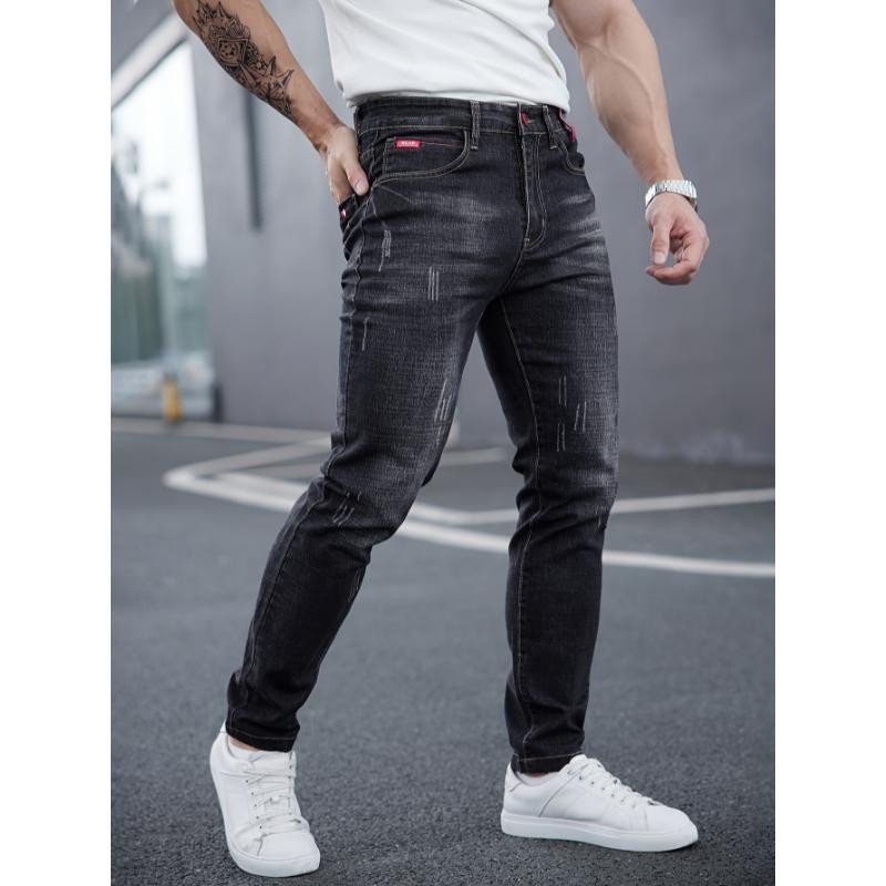 Men's ripped denim jeans by Ancient Energy featuring cat-whisker scratches and distressed details for a rugged look.