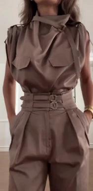 Ancient Energy shoulder slimming waist belt paired with a blouse and pants, showcasing a sleek, stylish outfit.