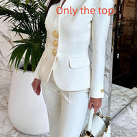 Solid color single-breasted blazer and high-waisted pants set by Ancient Energy, shown on a model, in a stylish, modern fit.