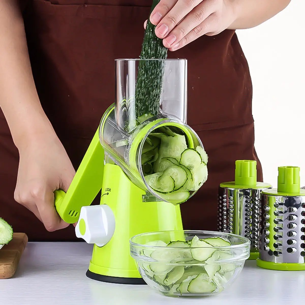 Ancient Energy round vegetable cutter and mandoline slicer with julienne and grater attachments for potatoes, carrots, and cheese.